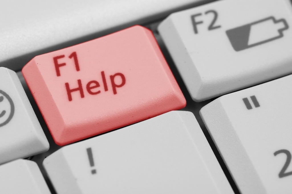 Computer keyboard with red button saying "F1 - Help"